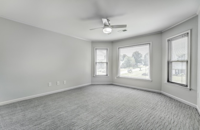 carpeted spare room featuring ceiling fan and ornamental molding