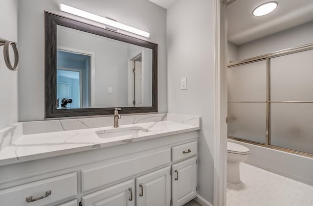 full bathroom featuring vanity, tile patterned flooring, bath / shower combo with glass door, and toilet