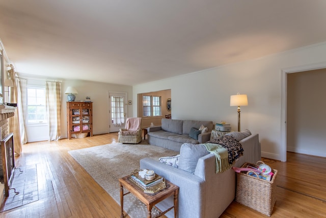 living room with a fireplace and light wood-type flooring