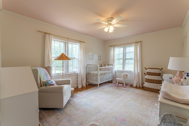 sitting room featuring crown molding, hardwood / wood-style floors, and ceiling fan