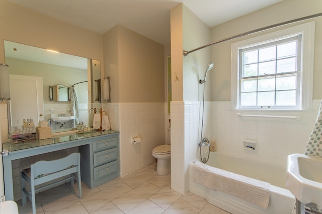 full bathroom with shower / tub combination, toilet, vanity, tile walls, and tile patterned floors