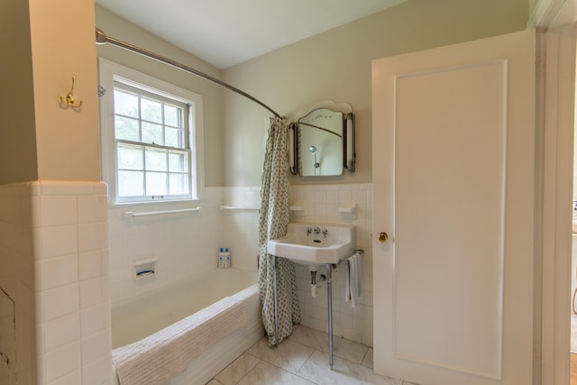 bathroom featuring tile walls, tile patterned floors, sink, and shower / bath combination with curtain