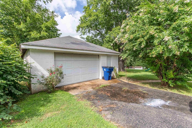 garage featuring a lawn