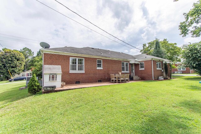 back of property featuring a patio and a lawn