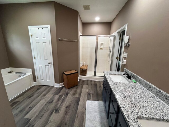 bathroom featuring separate shower and tub, hardwood / wood-style floors, and vanity