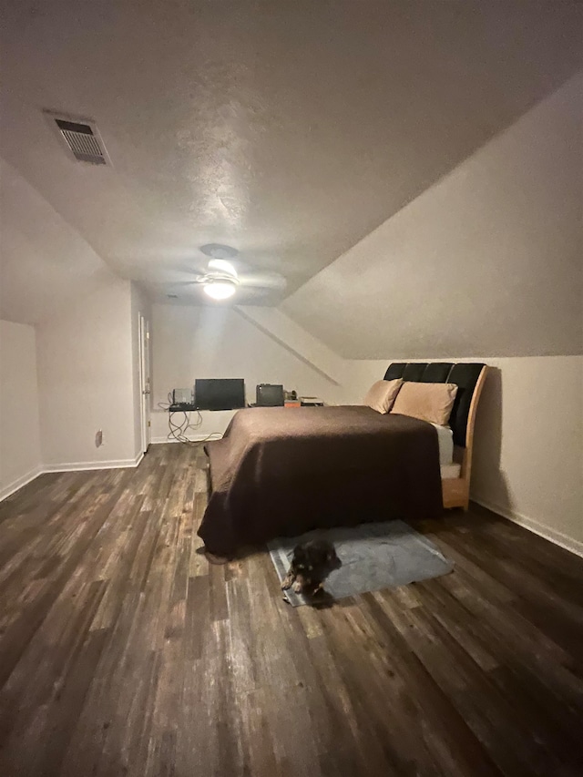 bedroom featuring hardwood / wood-style flooring, a textured ceiling, vaulted ceiling, and ceiling fan