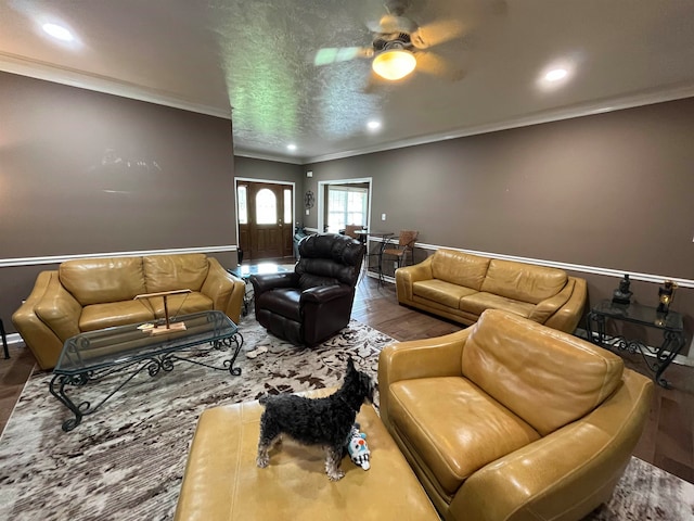 living room with ornamental molding, hardwood / wood-style flooring, and ceiling fan