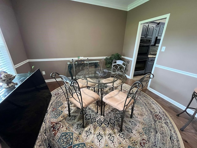 dining room featuring wood-type flooring and ornamental molding