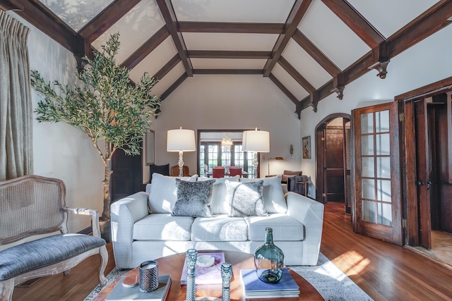 living room with wood-type flooring, high vaulted ceiling, and beamed ceiling