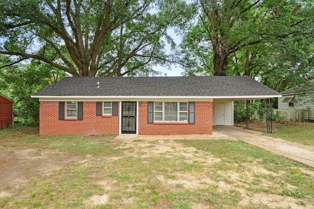 single story home featuring a carport and a front lawn