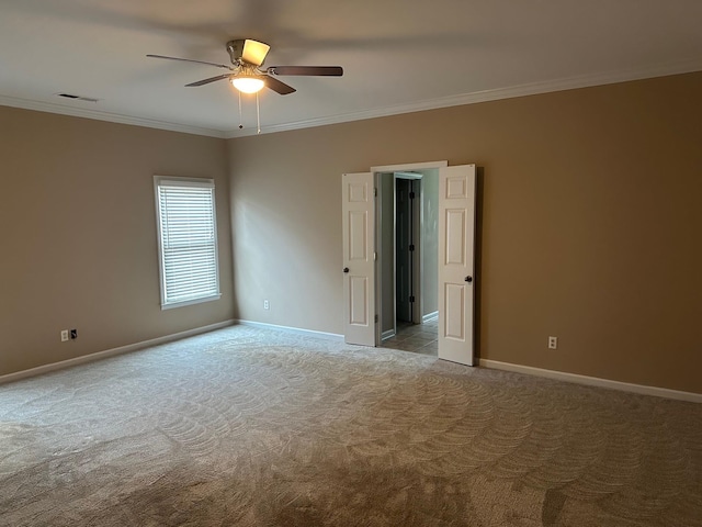 spare room with light carpet, ornamental molding, and ceiling fan