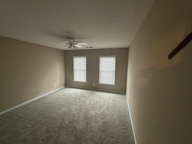 spare room with ceiling fan, carpet flooring, and a textured ceiling