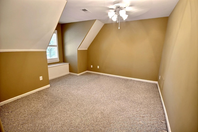 bonus room with vaulted ceiling, carpet flooring, and ceiling fan