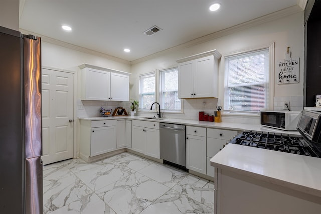 kitchen featuring sink, stainless steel dishwasher, white cabinets, and refrigerator