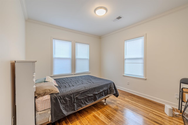 bedroom with wood-type flooring and crown molding