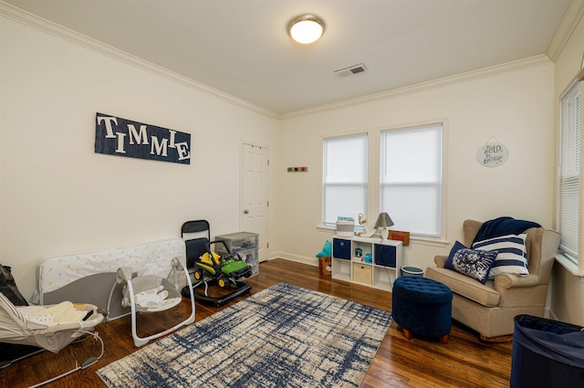 living area with crown molding and dark hardwood / wood-style flooring