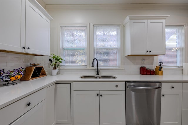 kitchen featuring a healthy amount of sunlight, sink, white cabinets, and dishwasher