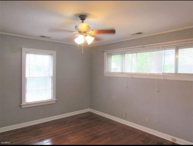 spare room with dark hardwood / wood-style floors, ornamental molding, and ceiling fan