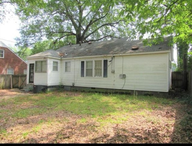 rear view of house featuring central AC