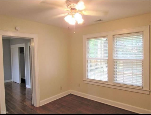 spare room featuring ceiling fan and dark hardwood / wood-style floors