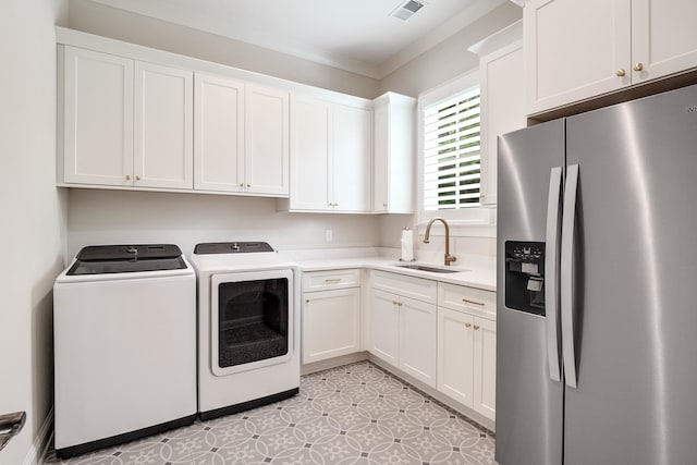 washroom featuring sink, light tile patterned floors, independent washer and dryer, and crown molding