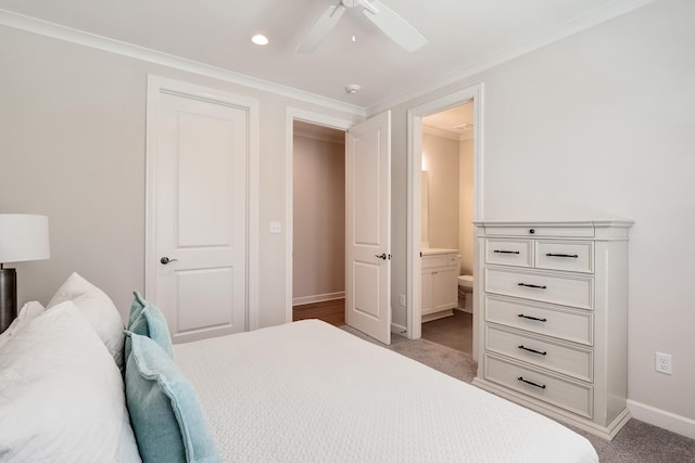 bedroom featuring crown molding, light colored carpet, ensuite bathroom, and ceiling fan