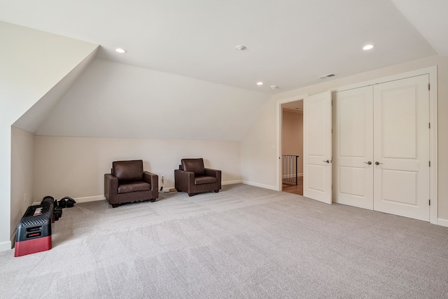 sitting room featuring light carpet and vaulted ceiling