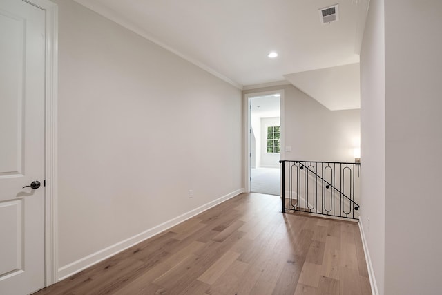 spare room with hardwood / wood-style flooring and ornamental molding