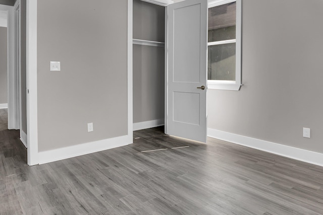 unfurnished bedroom featuring hardwood / wood-style flooring and a closet