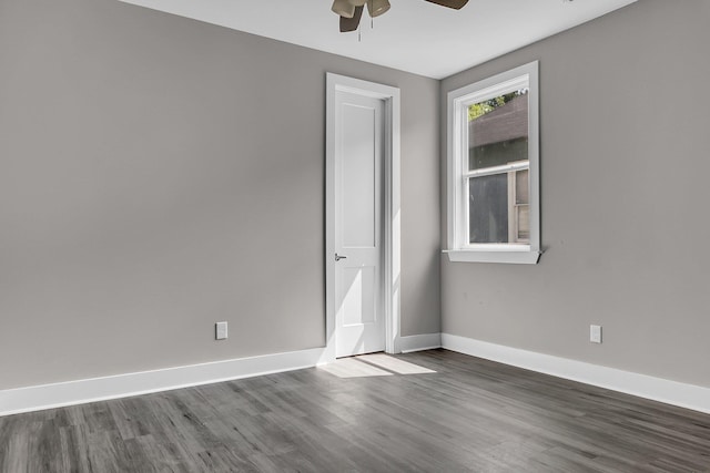 spare room with dark wood-type flooring and ceiling fan