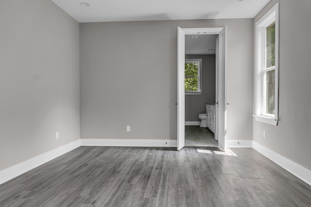 empty room with dark hardwood / wood-style floors