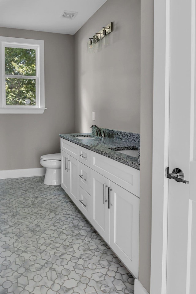 bathroom featuring vanity and toilet