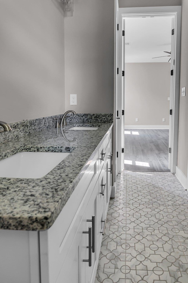 bathroom featuring tile patterned flooring, vanity, and ceiling fan