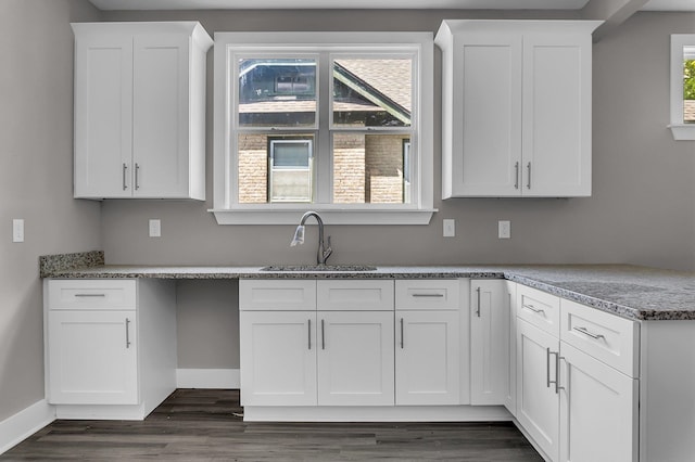 kitchen with white cabinetry, plenty of natural light, and sink