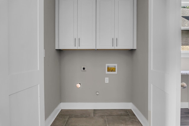 laundry area with gas dryer hookup, cabinets, plenty of natural light, washer hookup, and hookup for an electric dryer