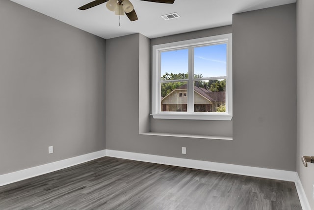 spare room with dark hardwood / wood-style flooring and ceiling fan