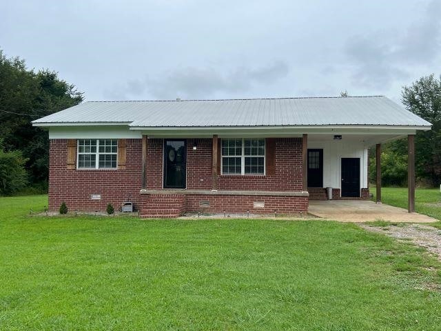 single story home with a front lawn and a carport