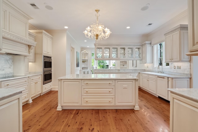 kitchen with pendant lighting, ornamental molding, dishwasher, and a kitchen island