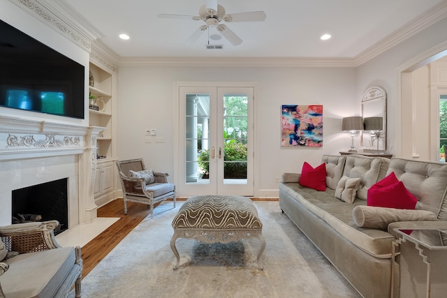 living room with crown molding, hardwood / wood-style flooring, and a wealth of natural light