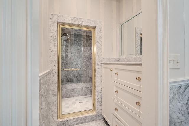 bathroom featuring vanity and a shower with shower door