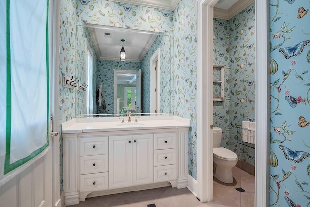 bathroom featuring vanity, crown molding, tile patterned floors, and toilet