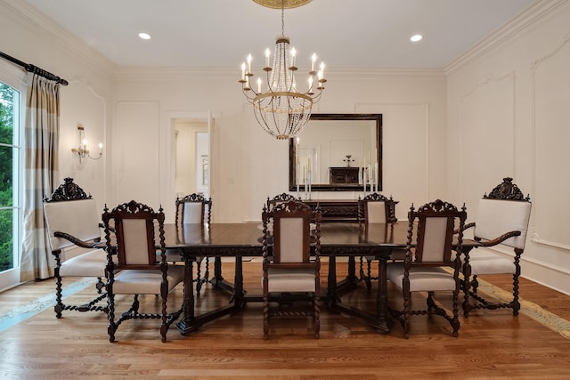 dining space featuring hardwood / wood-style flooring, crown molding, and an inviting chandelier