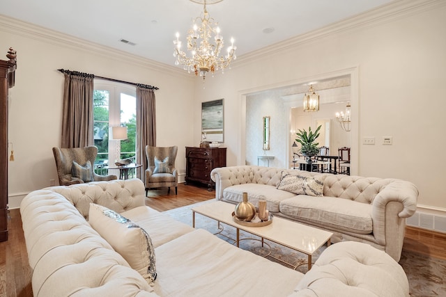 living room featuring crown molding, an inviting chandelier, and light wood-type flooring