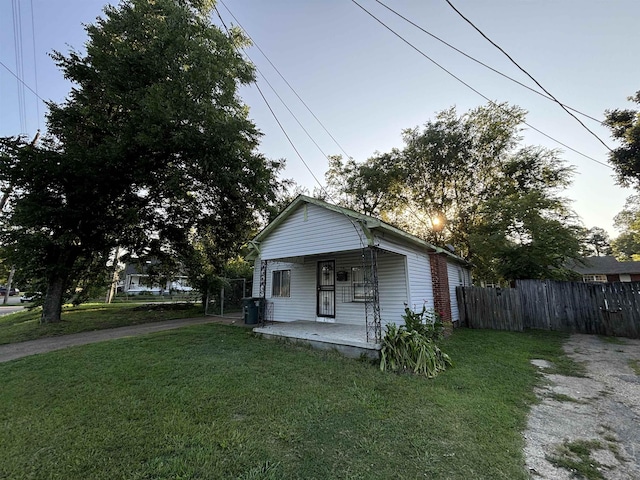 bungalow-style house featuring a porch and a lawn