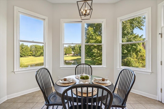 dining room featuring a notable chandelier and light tile patterned flooring