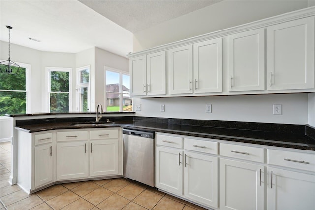 kitchen featuring sink, a textured ceiling, hanging light fixtures, stainless steel dishwasher, and white cabinets