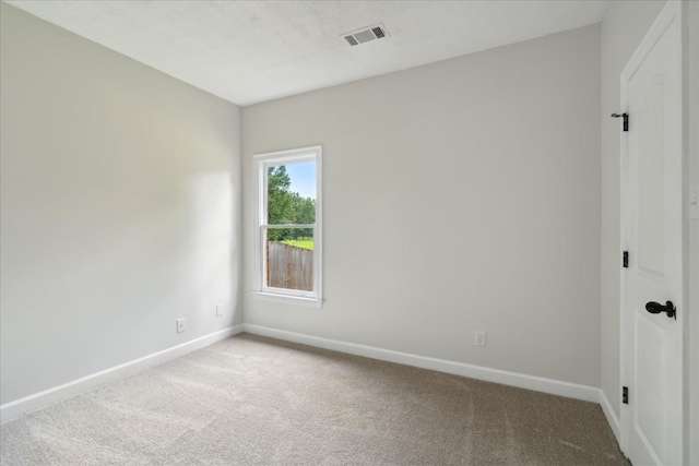 unfurnished room featuring light colored carpet