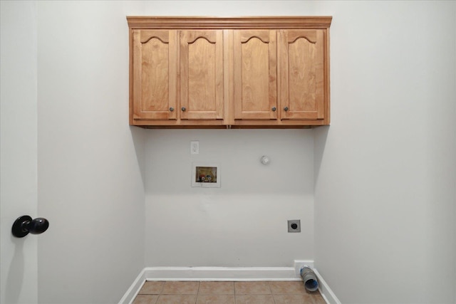 laundry area with gas dryer hookup, light tile patterned floors, cabinets, washer hookup, and hookup for an electric dryer