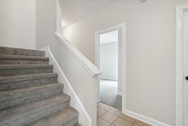 staircase with tile patterned floors