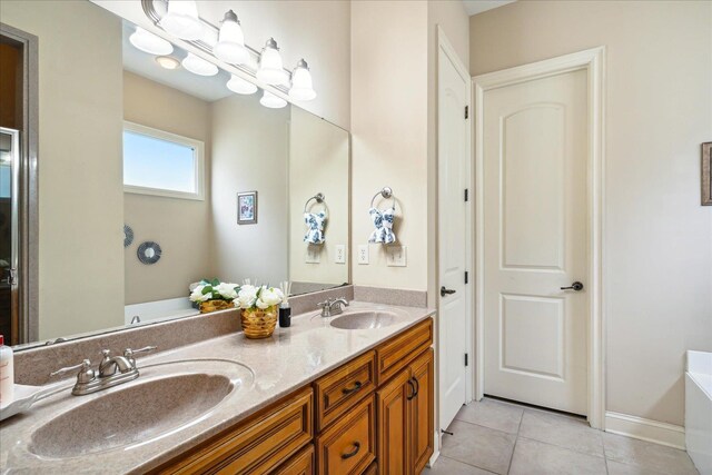 bathroom featuring dual vanity, tile patterned floors, and a bathing tub